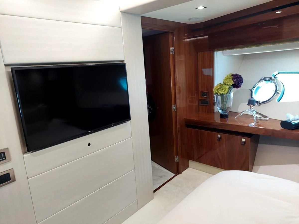 a room with a television and a table aboard SUNSEEKER 75 YACHT Yacht for Sale