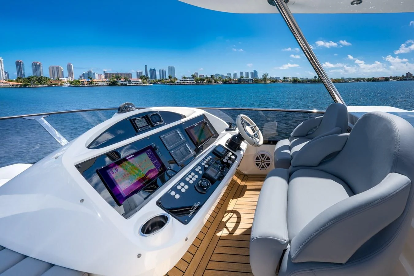 a boat with a view of a city in the background aboard SUNSEEKER 75 YACHT Yacht for Sale