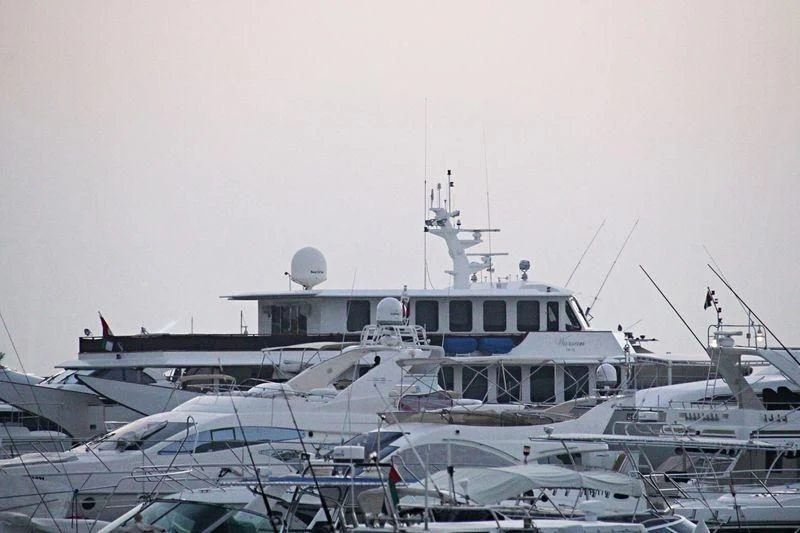 a large white boat in a harbor aboard WARSAN Yacht for Sale