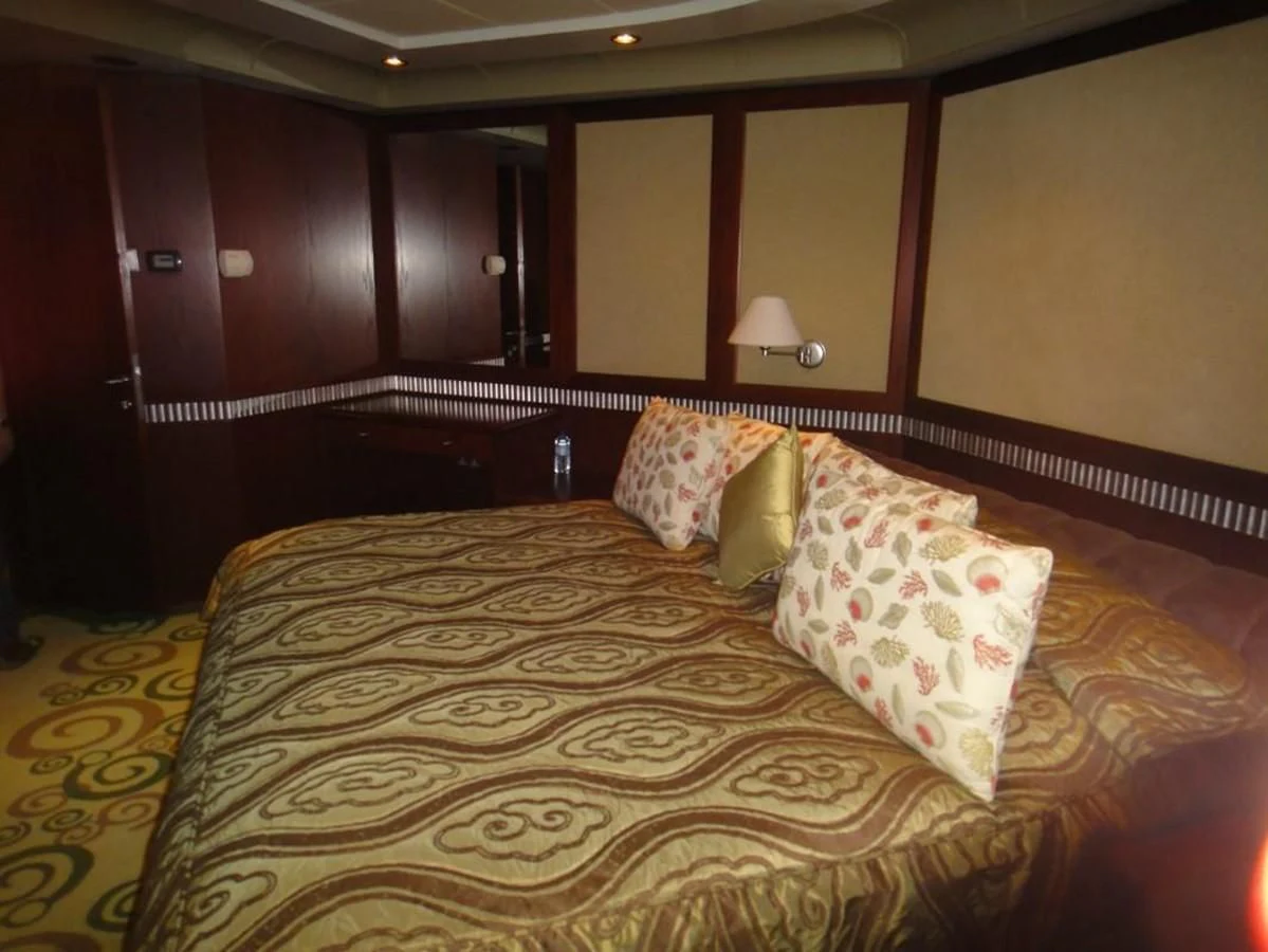 a bed with pillows aboard WARSAN Yacht for Sale