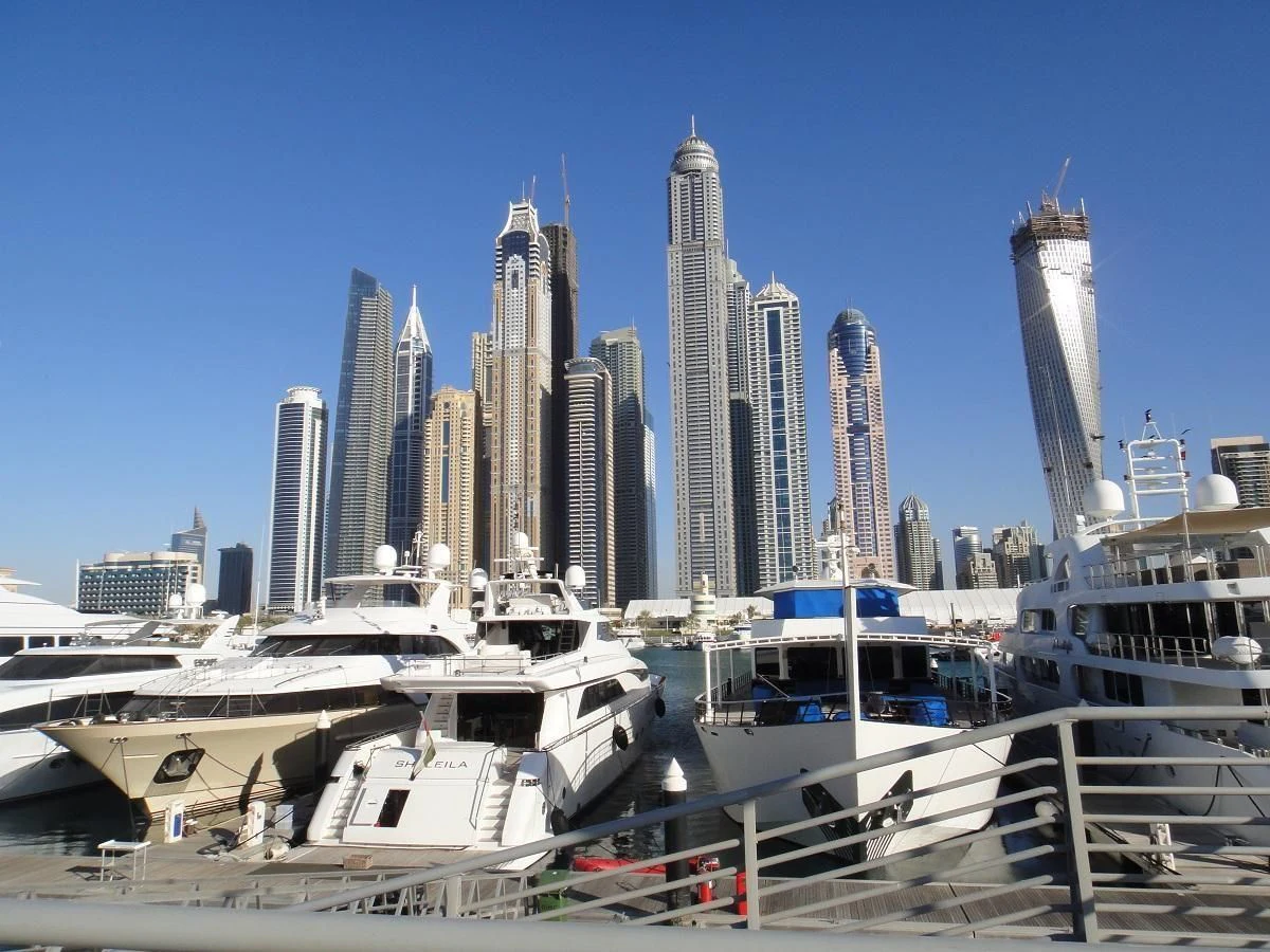 a city skyline with boats aboard WARSAN Yacht for Sale