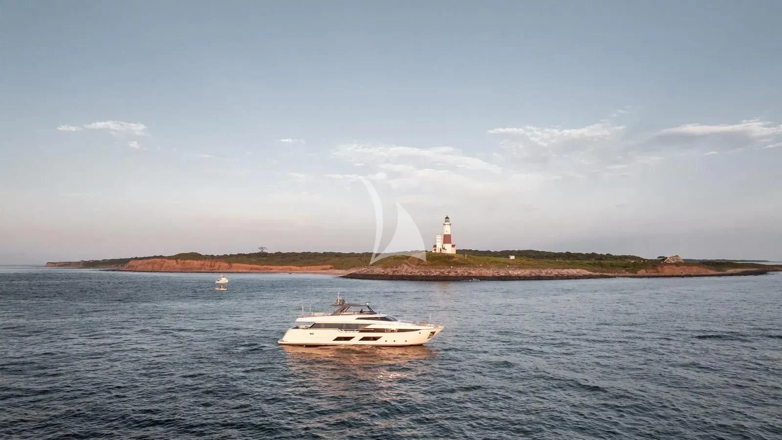 a boat in the water with a lighthouse in the background aboard DATE NIGHT Yacht for Sale
