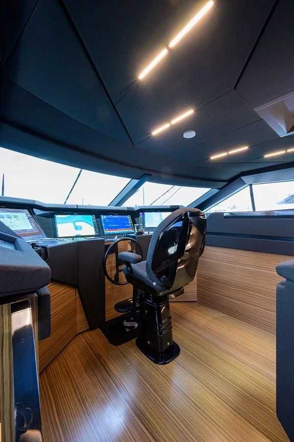 a black office chair in a room with many computers on the floor aboard DATE NIGHT Yacht for Sale