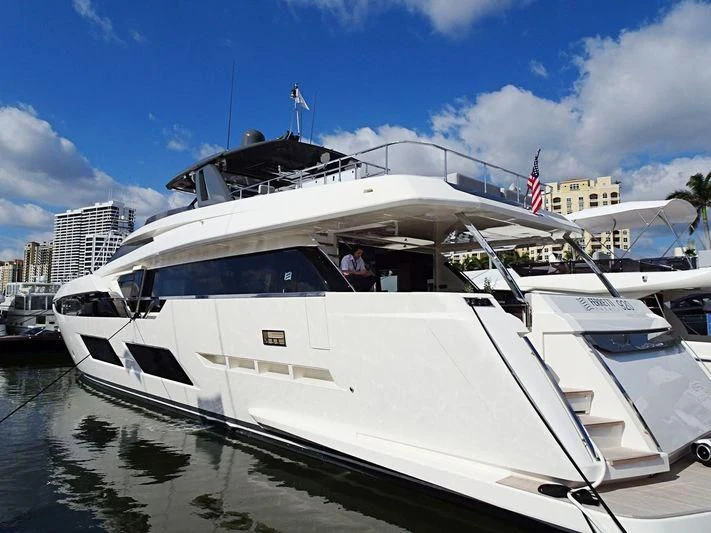 a white yacht in a harbor aboard DATE NIGHT Yacht for Sale