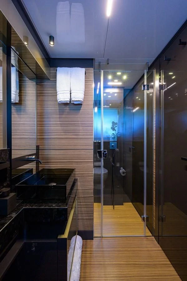 a bathroom with a shower and sinks aboard DATE NIGHT Yacht for Sale