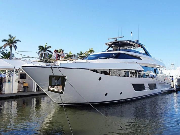 a white yacht docked at a pier aboard DATE NIGHT Yacht for Sale