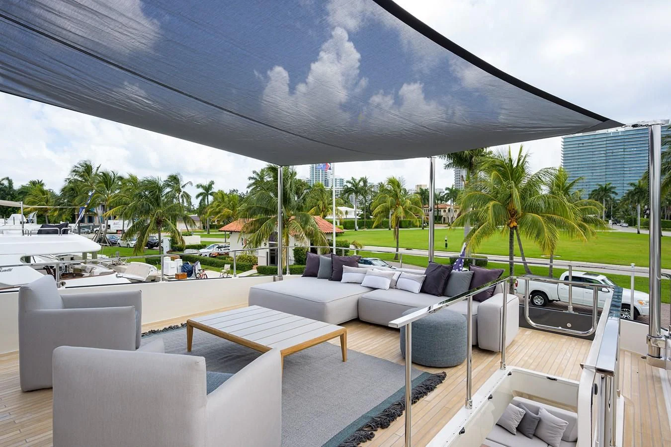 a patio with a patio area and chairs and a large umbrella aboard DATE NIGHT Yacht for Sale