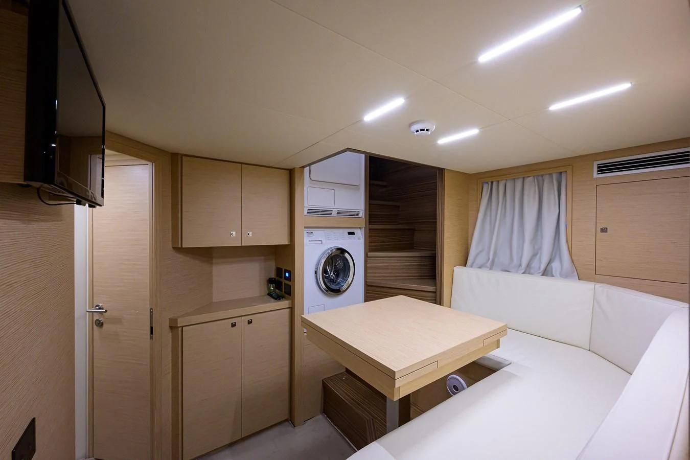 a room with a bed and a washing machine aboard DATE NIGHT Yacht for Sale