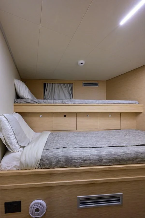 a bed with a white pillow aboard DATE NIGHT Yacht for Sale