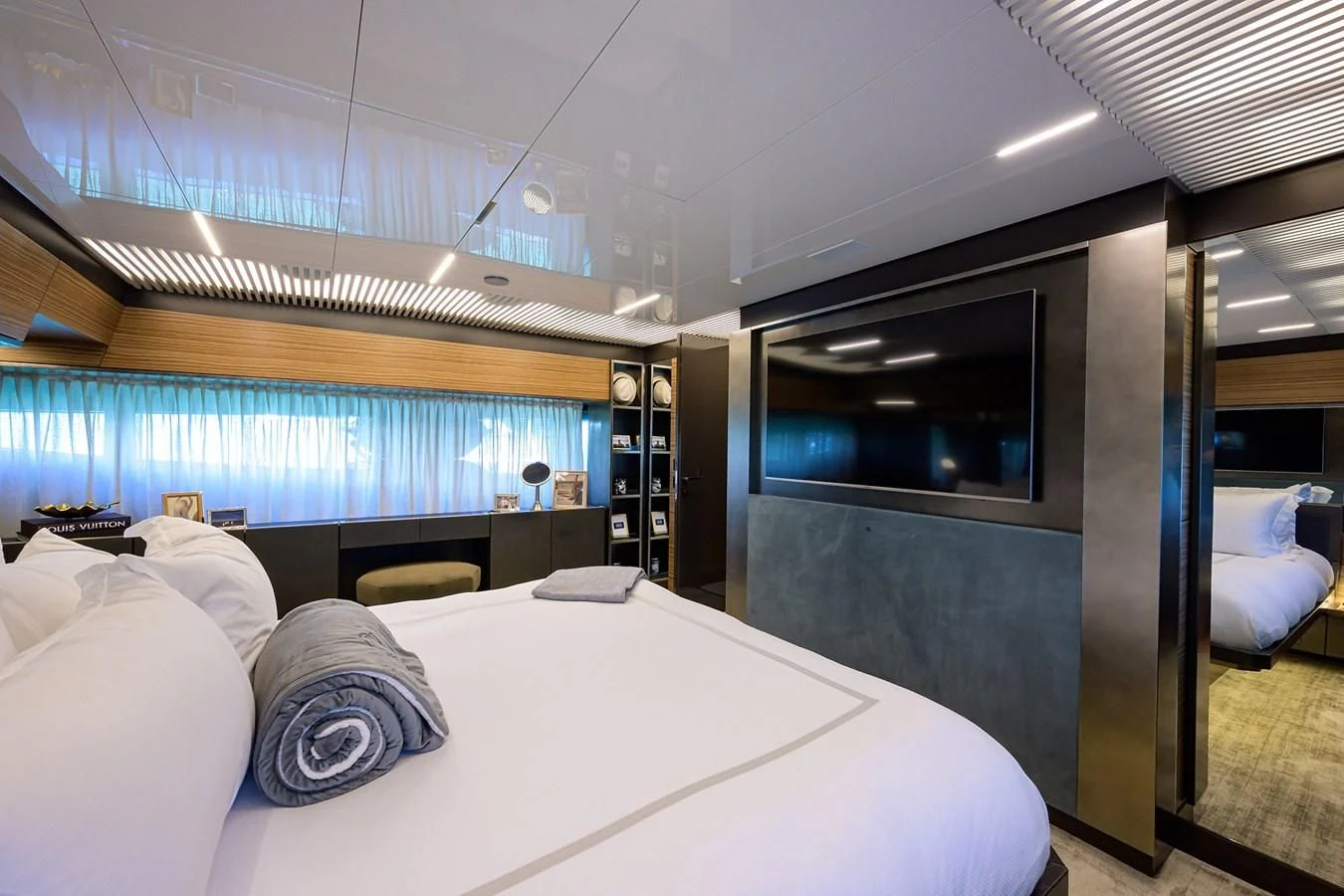 a room with a bed and a large window aboard DATE NIGHT Yacht for Sale
