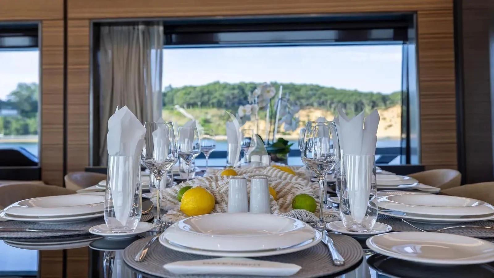a table with plates and glasses aboard DATE NIGHT Yacht for Sale