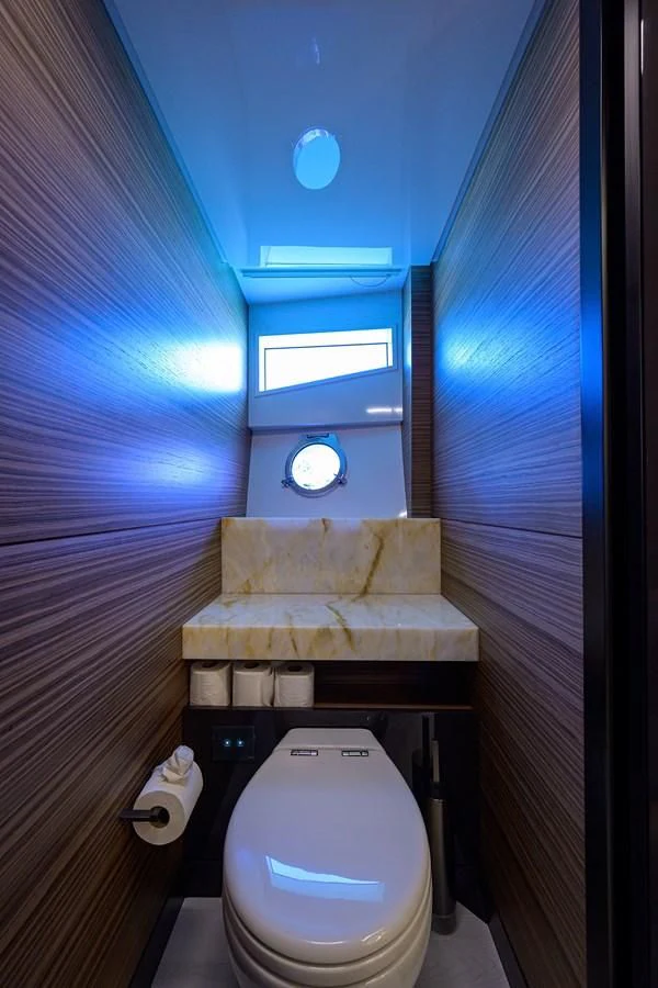 a bathroom with a toilet and a bed aboard DATE NIGHT Yacht for Sale