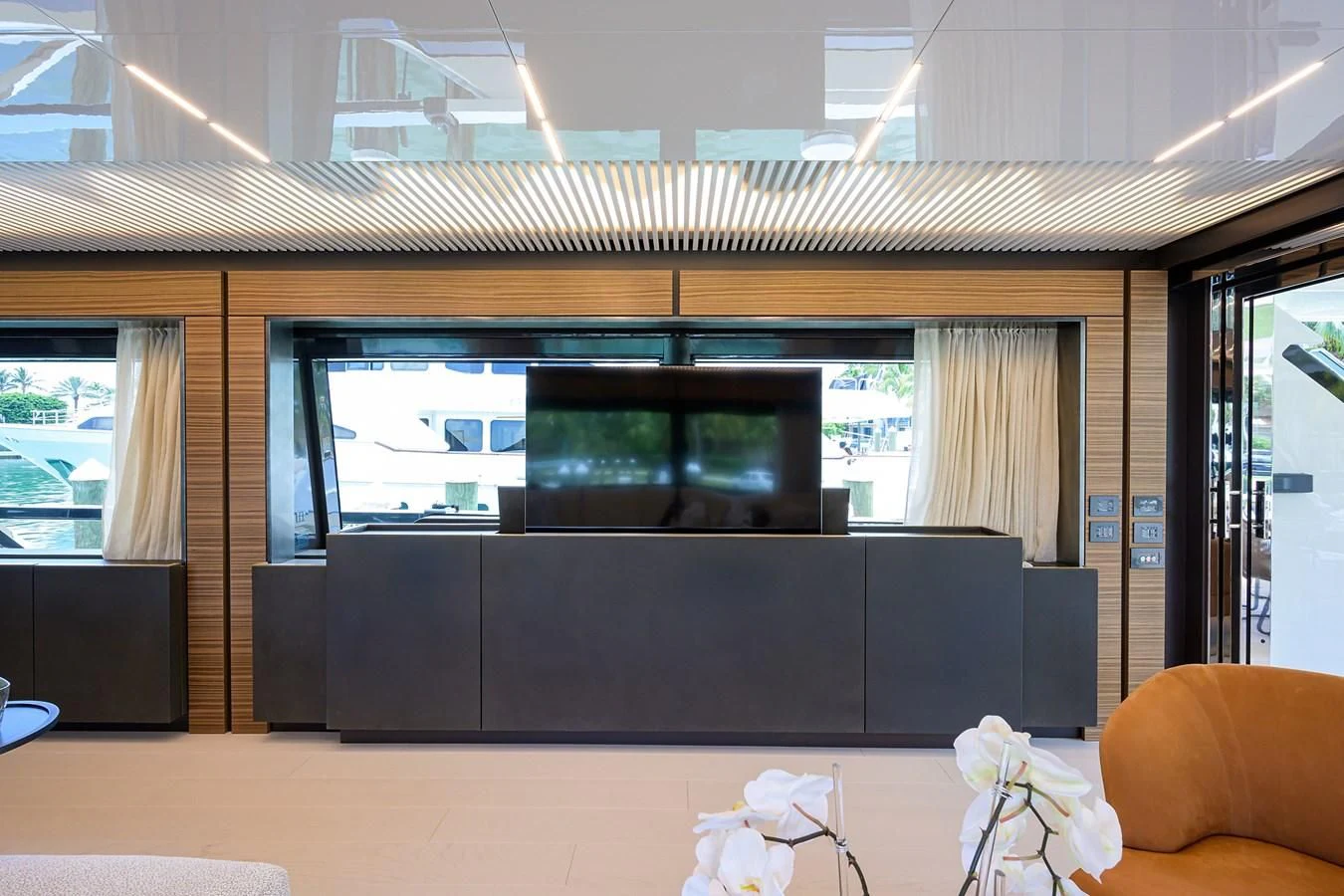 a room with a tv and couches aboard DATE NIGHT Yacht for Sale