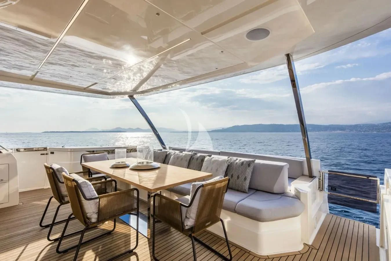 a table and chairs on a deck overlooking a large body of water aboard DATE NIGHT Yacht for Sale