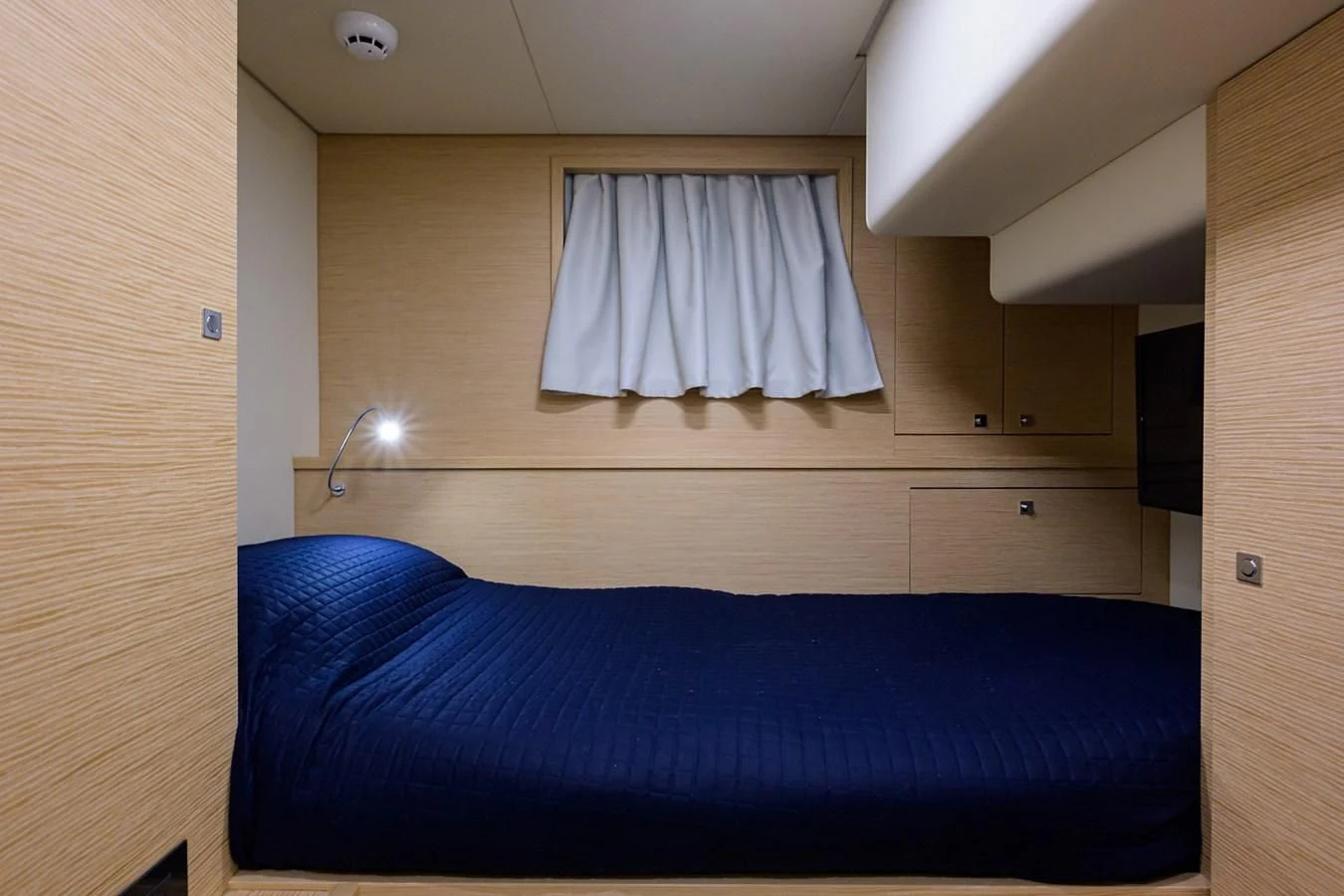 a bed with a blue sheet aboard DATE NIGHT Yacht for Sale