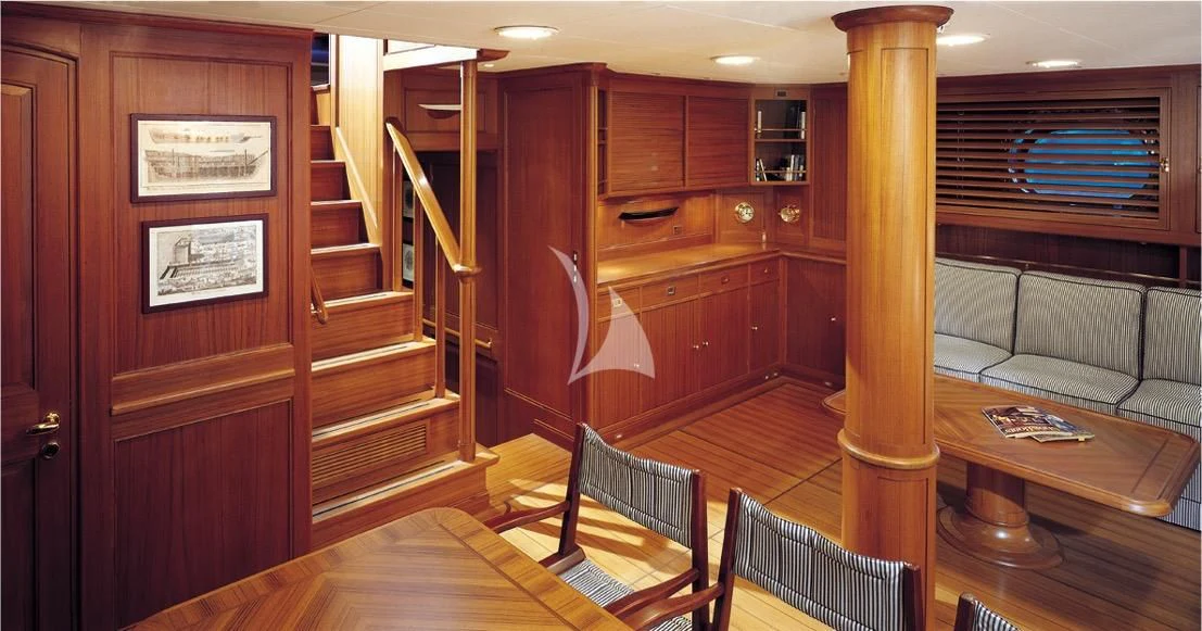 a room with wooden furniture aboard HERITAGE M Yacht for Charter