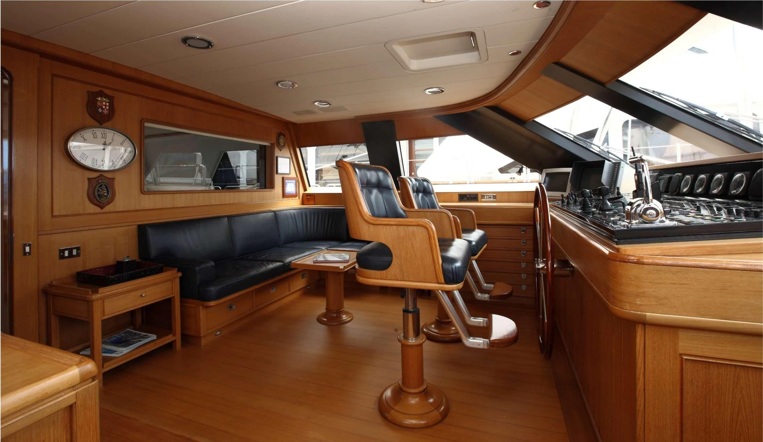 a room with a couch and a table and a chair aboard HERITAGE M Yacht for Charter