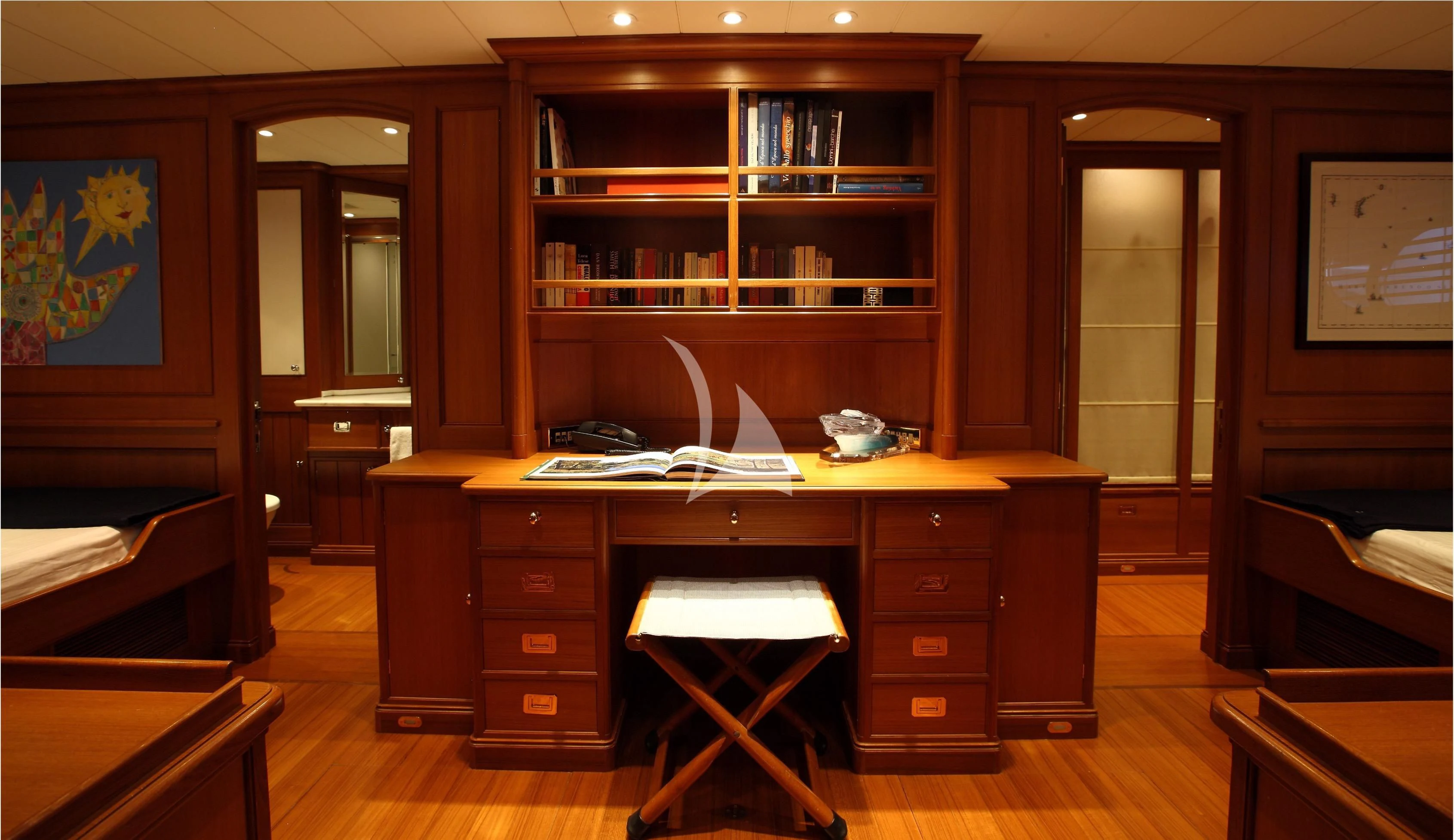 a room with a desk and a bookcase aboard HERITAGE M Yacht for Charter