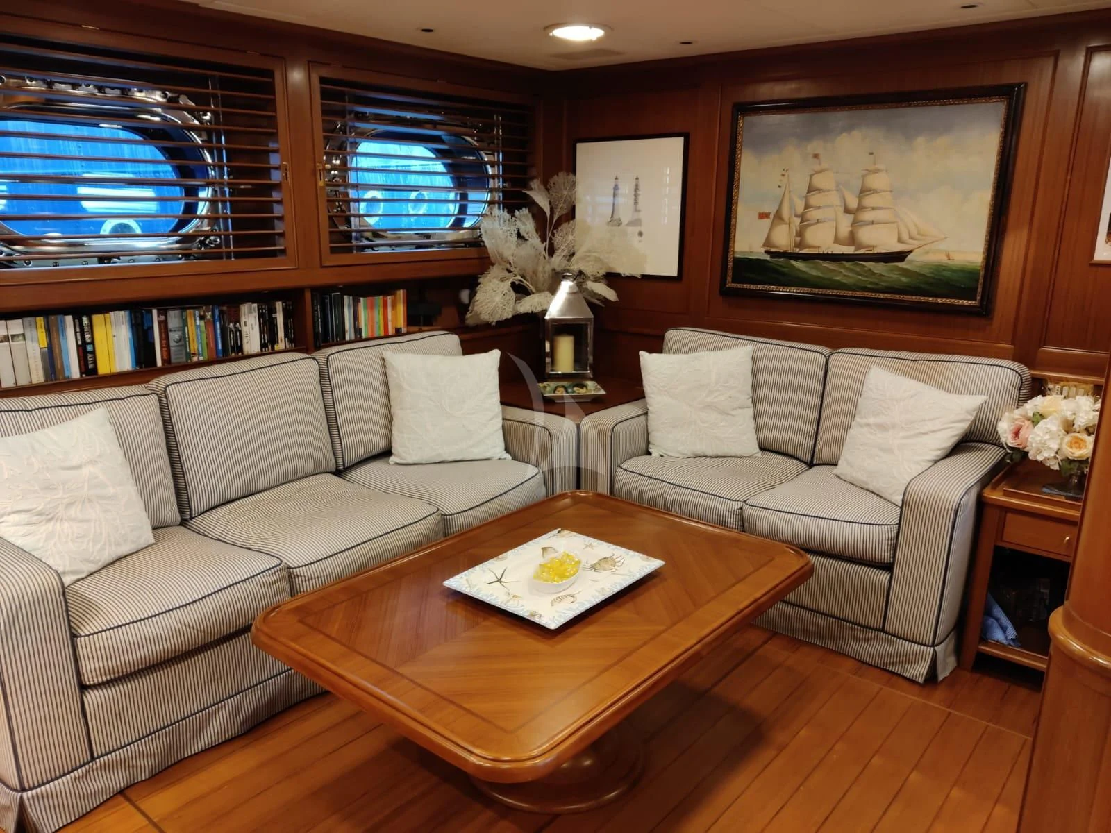 a living room with a couch and a coffee table aboard HERITAGE M Yacht for Charter