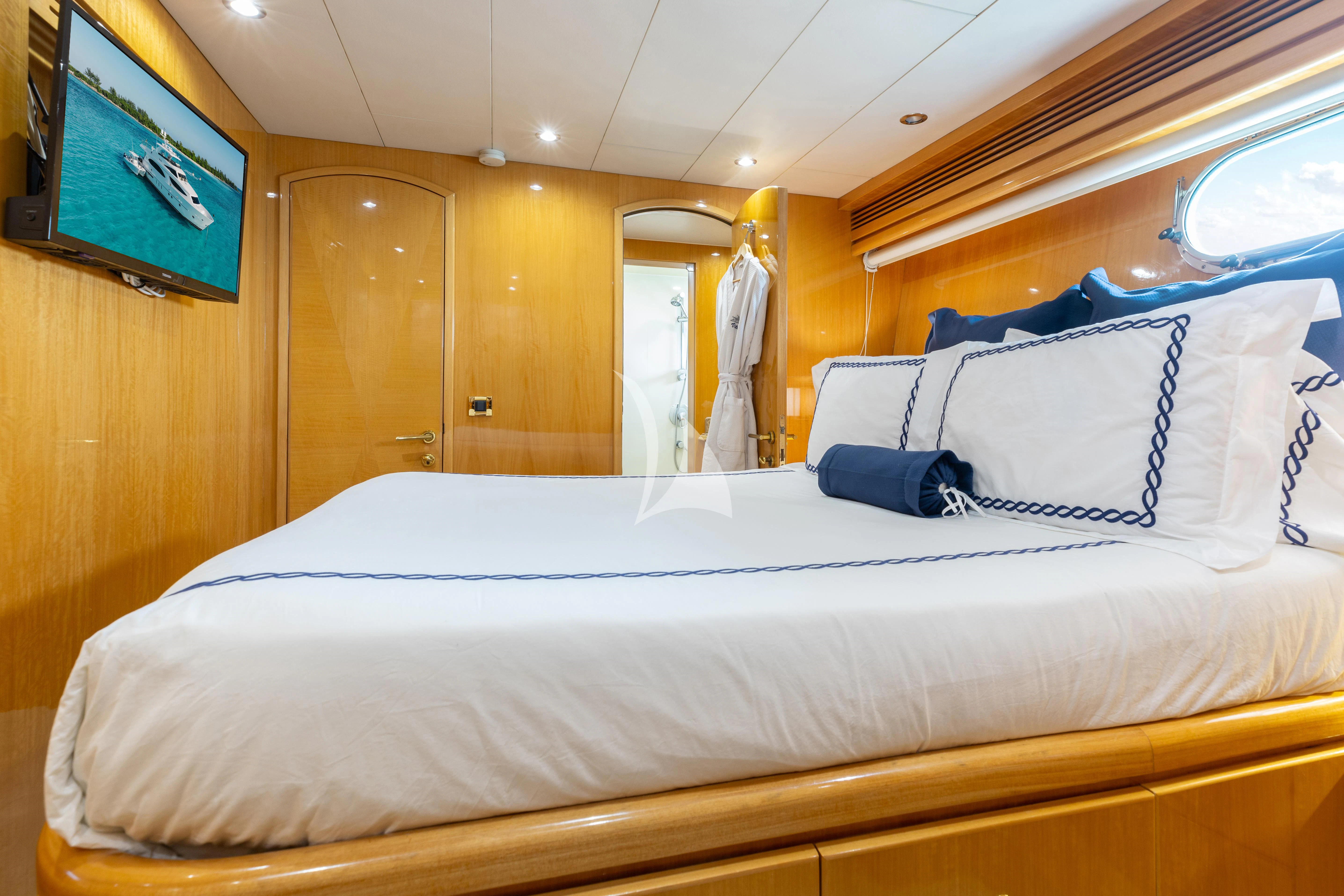 a bed with a white sheet and pillows aboard VITESSE Yacht for Sale