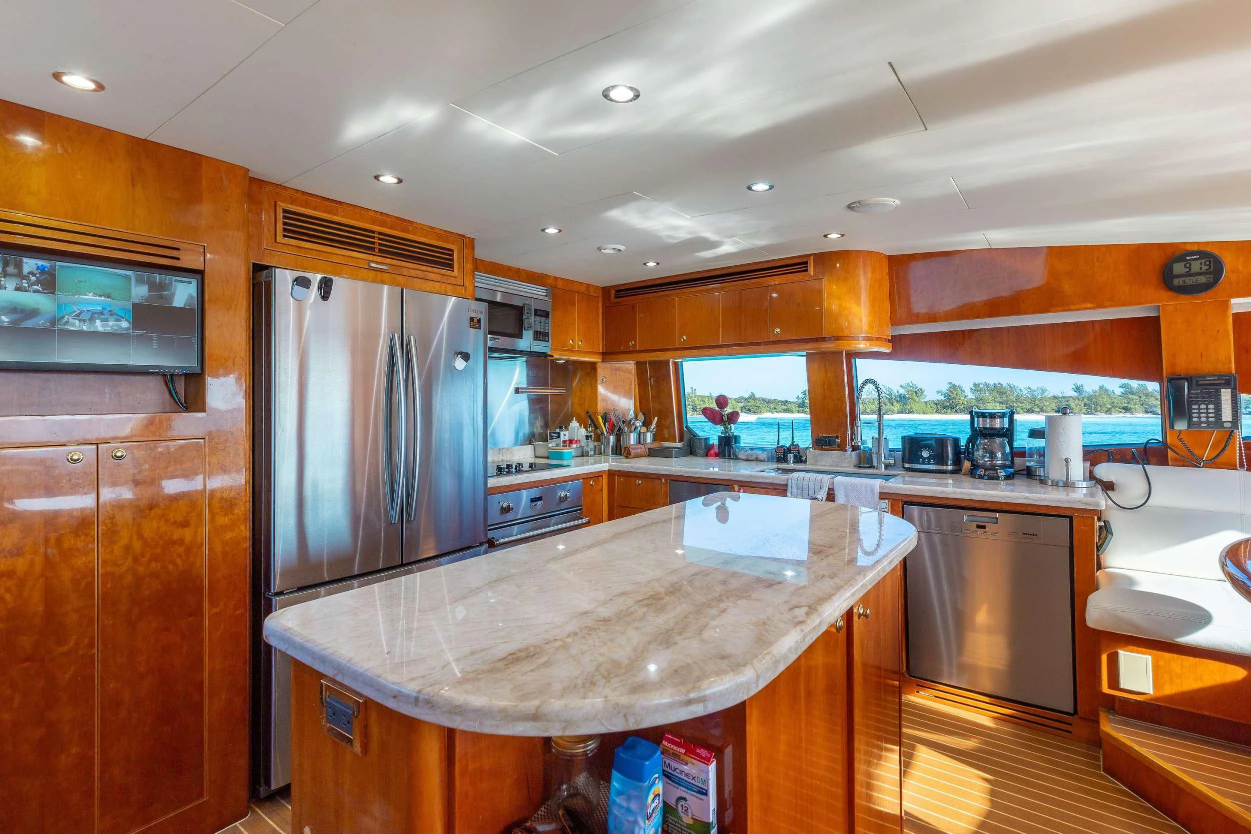 a kitchen with a stainless steel refrigerator aboard VITESSE Yacht for Sale