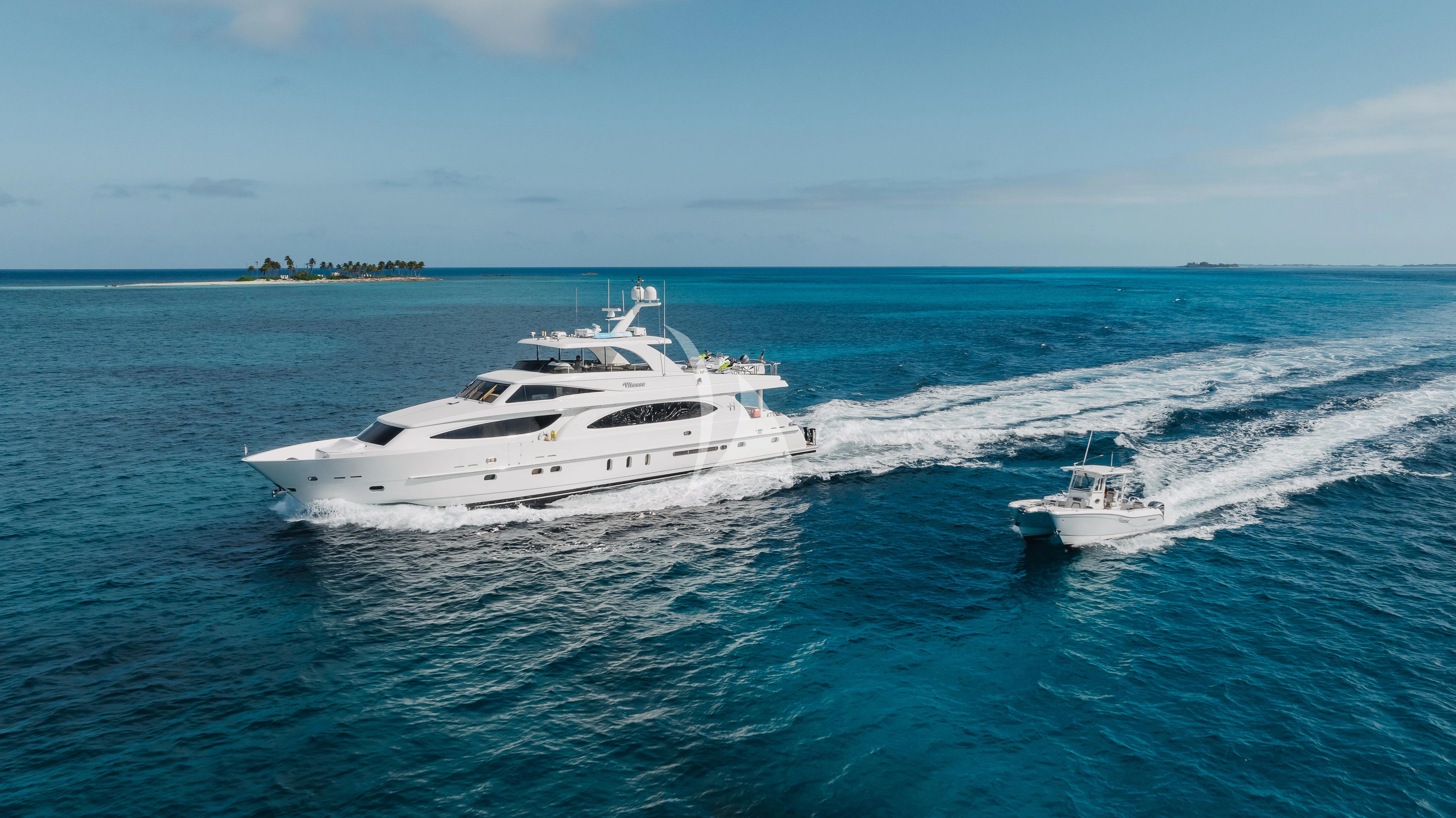 a couple of white yachts in the ocean aboard VITESSE Yacht for Sale