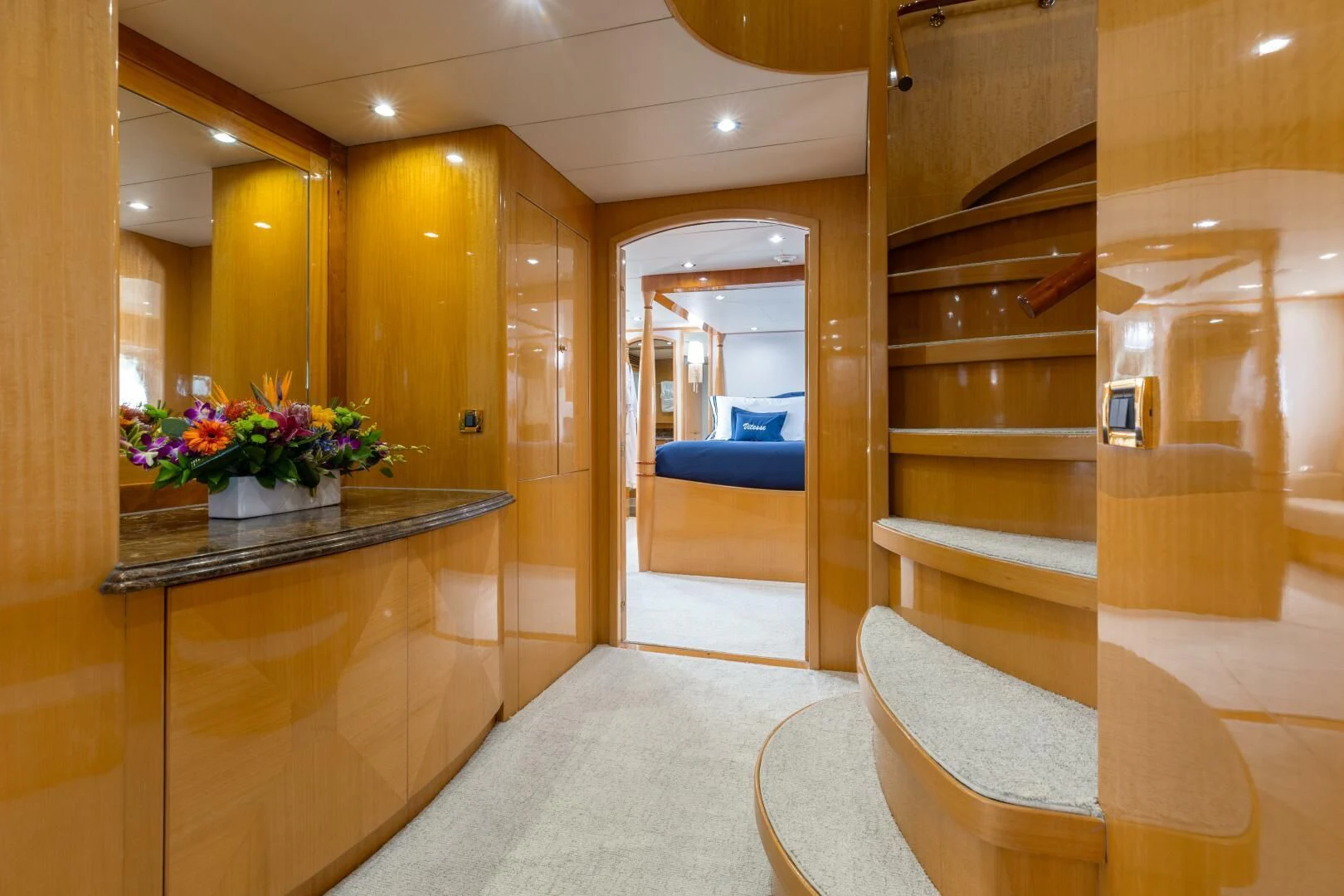 a room with a large mirror and a counter with chairs aboard VITESSE Yacht for Sale