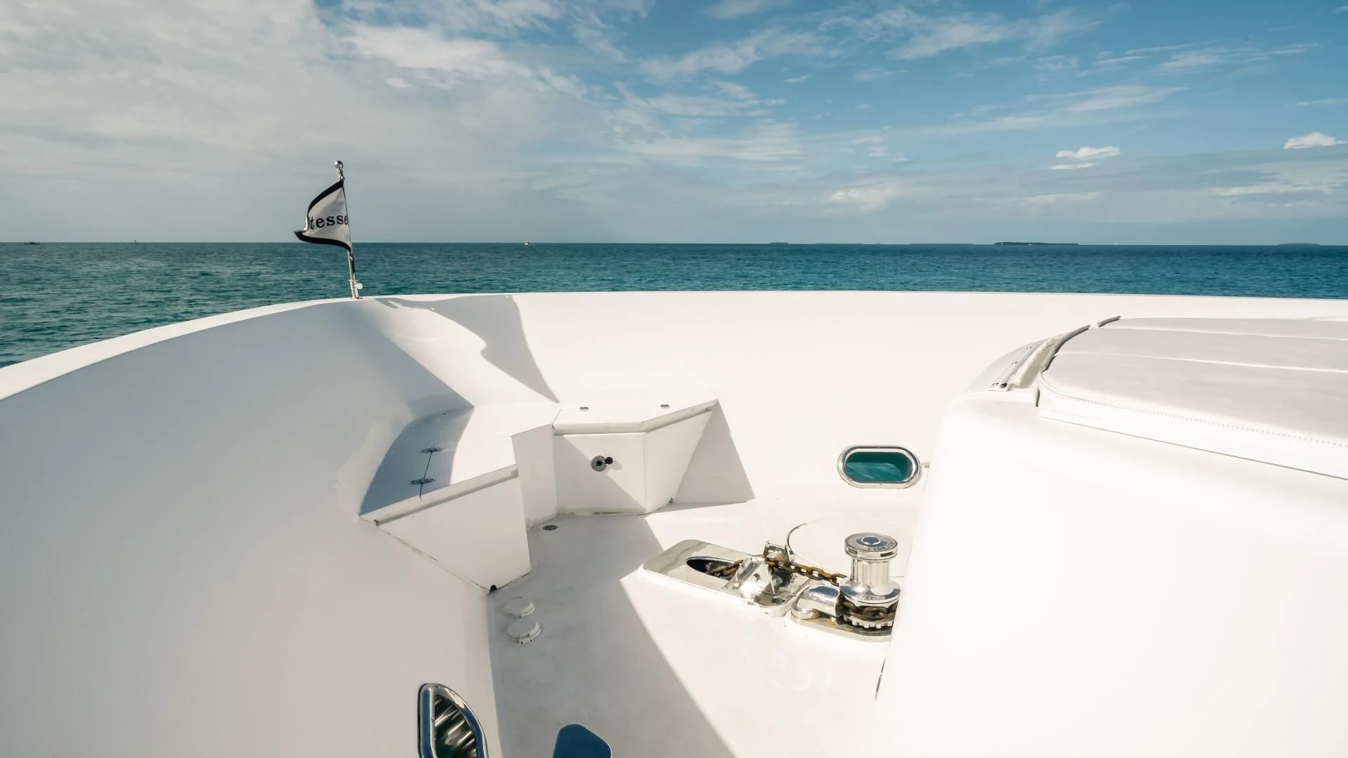 a white boat with a sail on the water aboard VITESSE Yacht for Sale