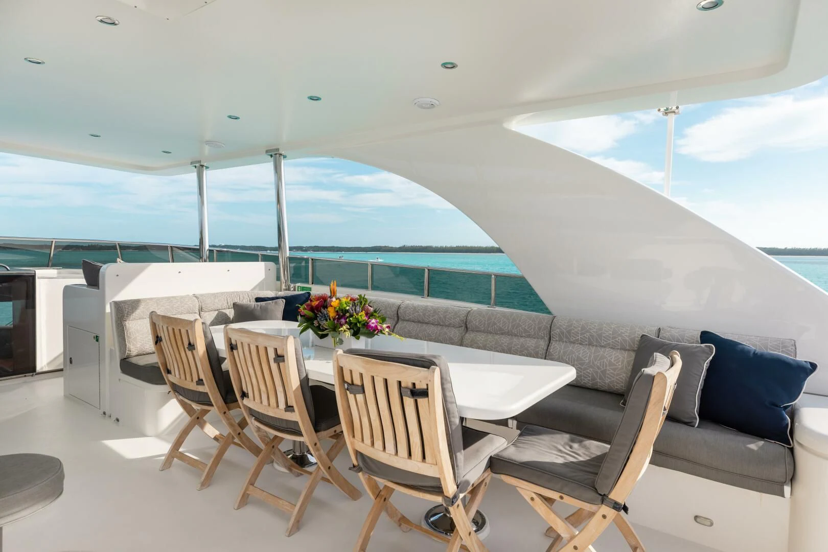 a room with a table chairs and a view of the ocean aboard VITESSE Yacht for Sale