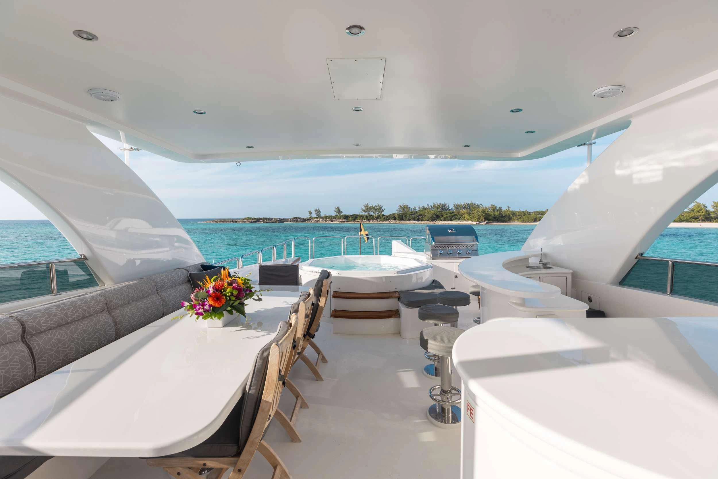 a room with a pool and a table with chairs and tables aboard VITESSE Yacht for Sale