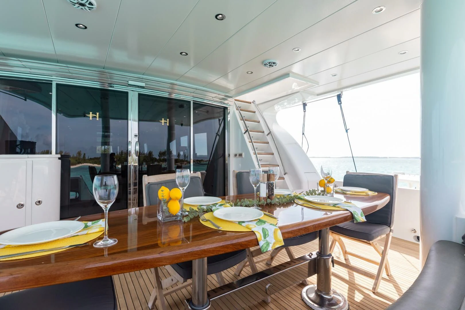 a dining table with glasses and plates aboard VITESSE Yacht for Sale