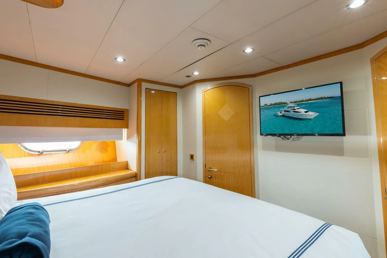 a room with a bed and a television on the wall aboard VITESSE Yacht for Sale