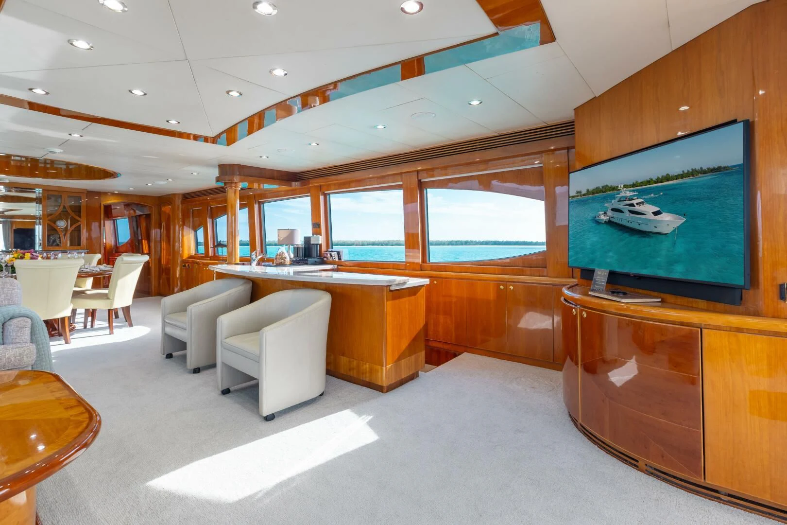 a room with a tv and a table aboard VITESSE Yacht for Sale