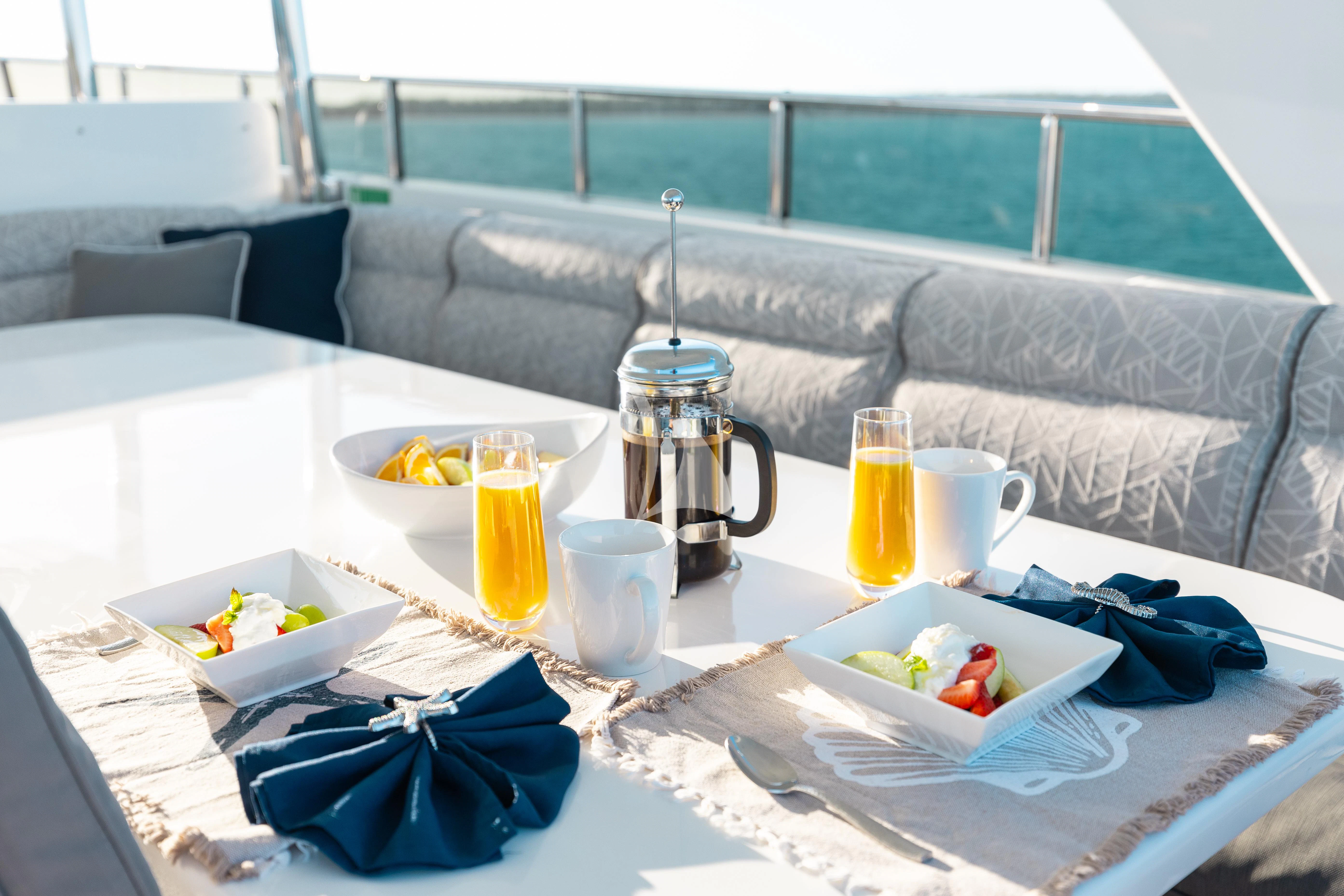 a table with food and drinks on it aboard VITESSE Yacht for Sale