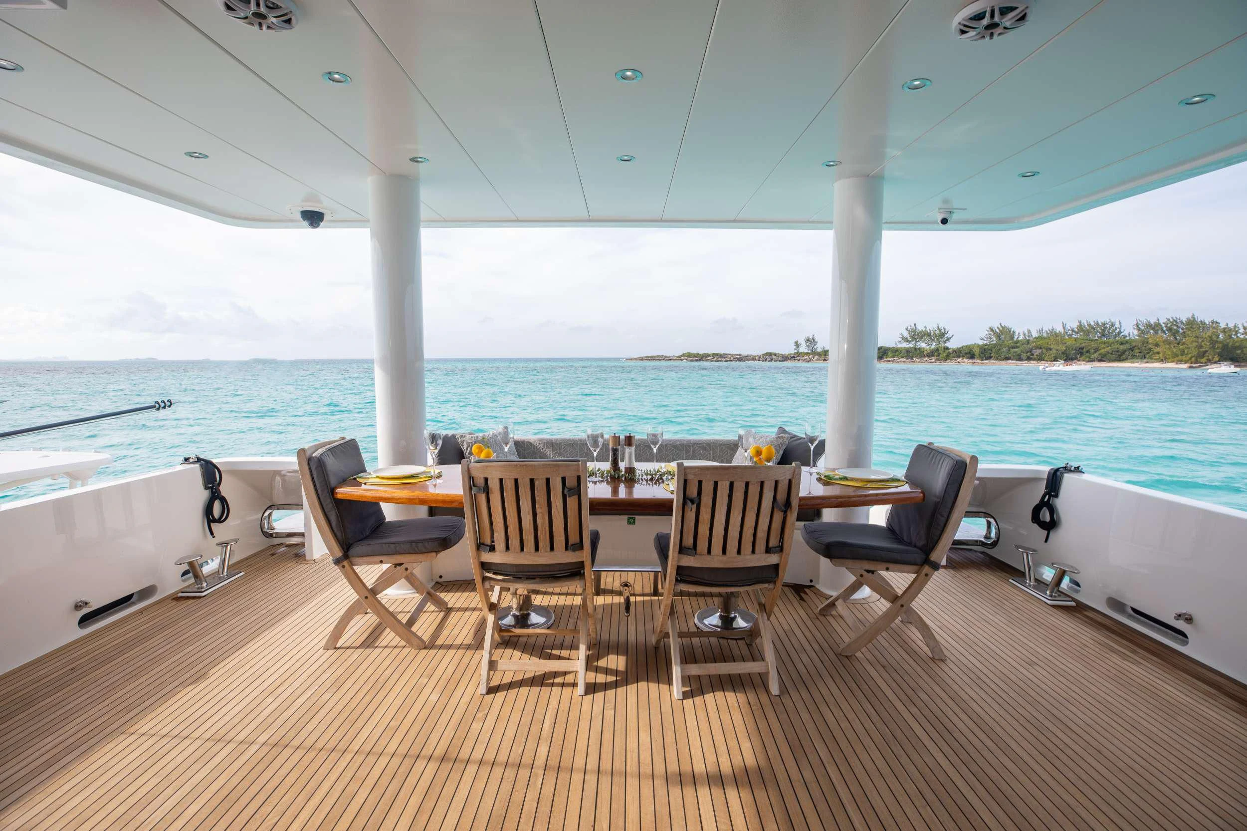 a deck with a table and chairs aboard VITESSE Yacht for Sale