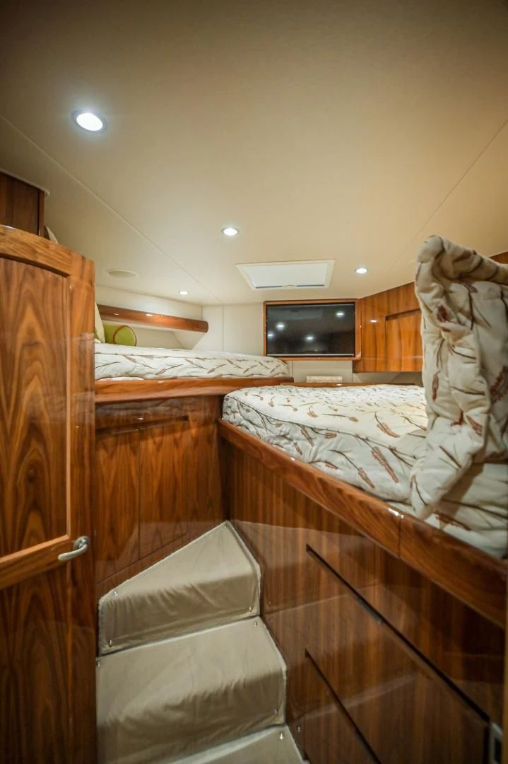 a bedroom with a bed and a television aboard GALATI  TRADE Yacht for Sale