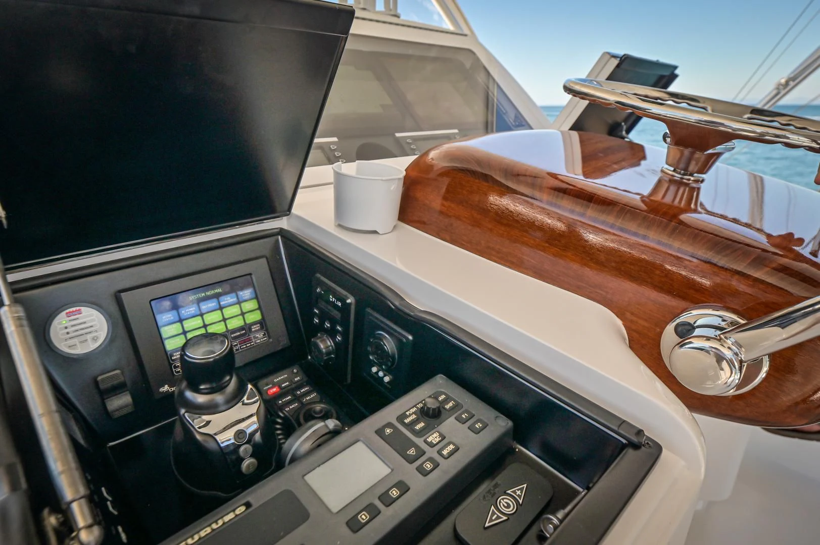 a car stereo with a cup and a cup on the dashboard aboard GALATI  TRADE Yacht for Sale