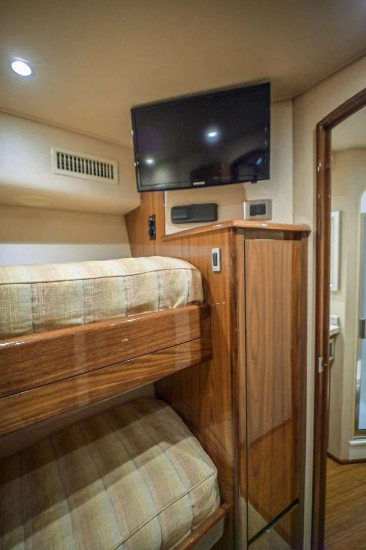 a bedroom with a tv on the wall aboard GALATI  TRADE Yacht for Sale