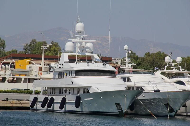 a large white boat in a harbor aboard HALCYON Yacht for Sale