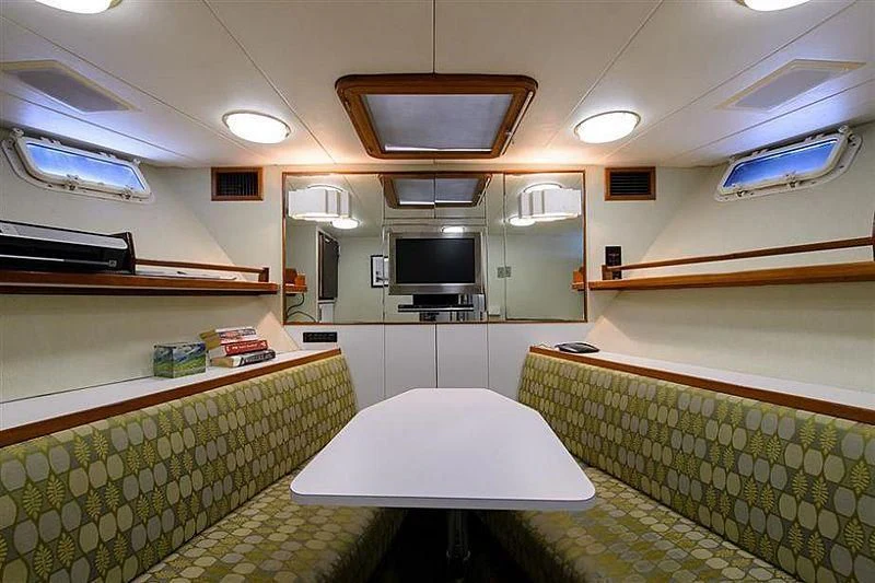 a room with a table and tv aboard SALLY JO II Yacht for Sale