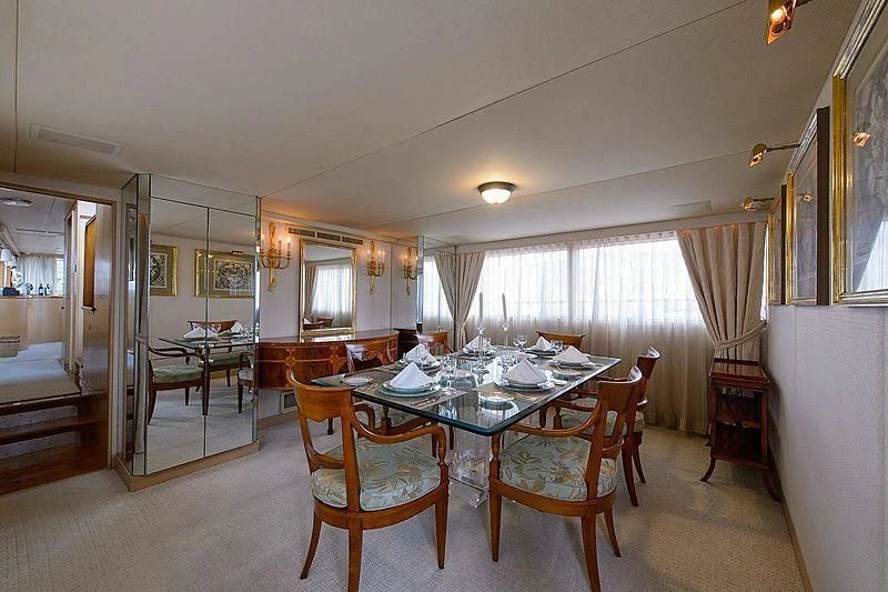a dining room with a table and chairs aboard SALLY JO II Yacht for Sale
