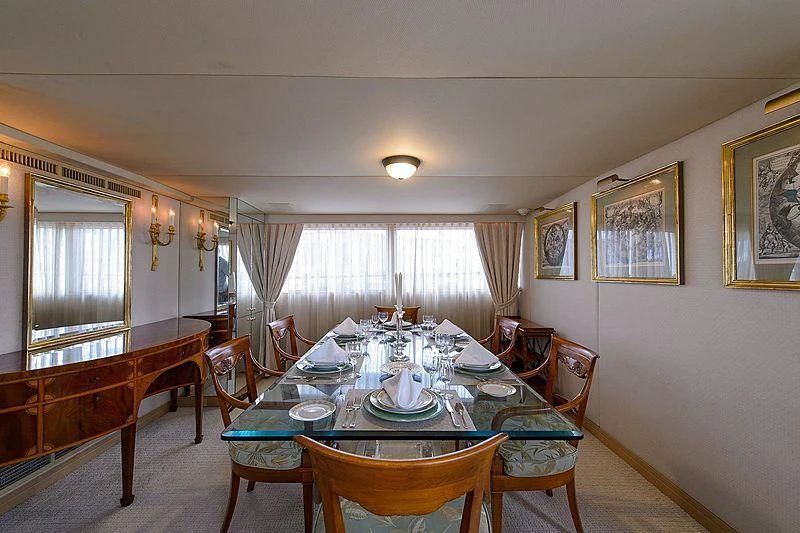 a dining table set for a family dinner aboard SALLY JO II Yacht for Sale