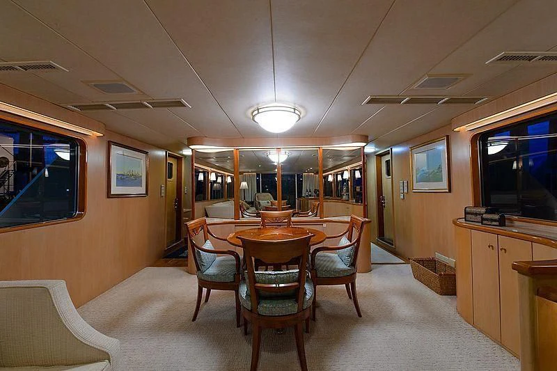 a room with a table and chairs aboard SALLY JO II Yacht for Sale