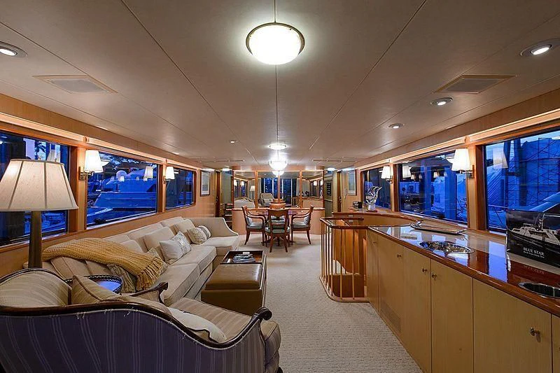 a large room with a couch and a table and chairs aboard SALLY JO II Yacht for Sale