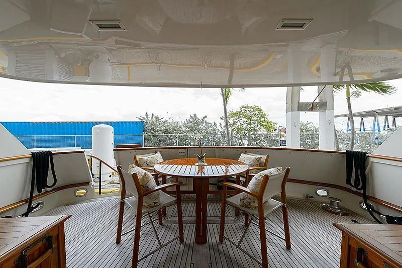 a room with tables and chairs aboard SALLY JO II Yacht for Sale