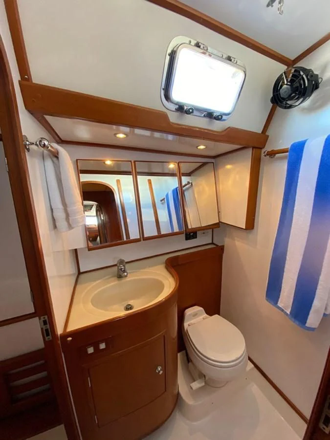 a bathroom with a sink and a toilet aboard EL CACIQUE Yacht for Sale