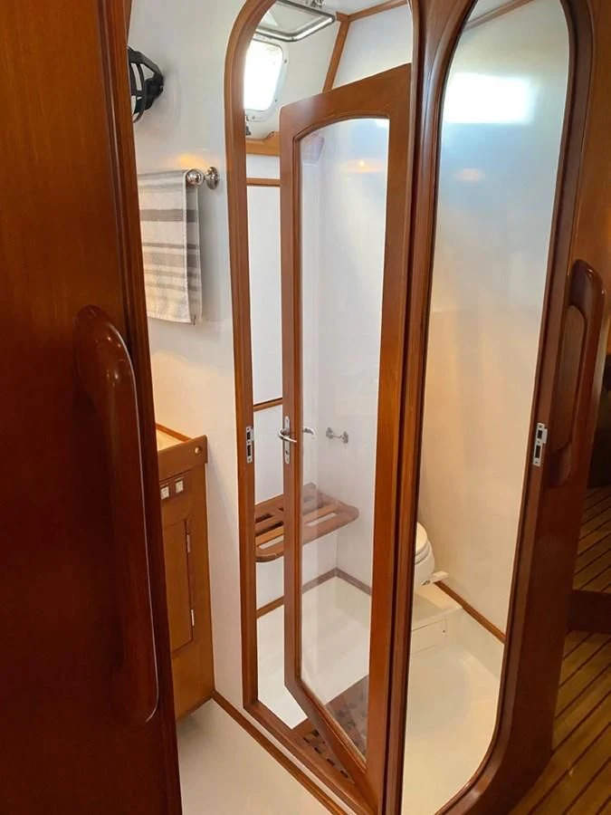 a bathroom with a glass shower aboard EL CACIQUE Yacht for Sale