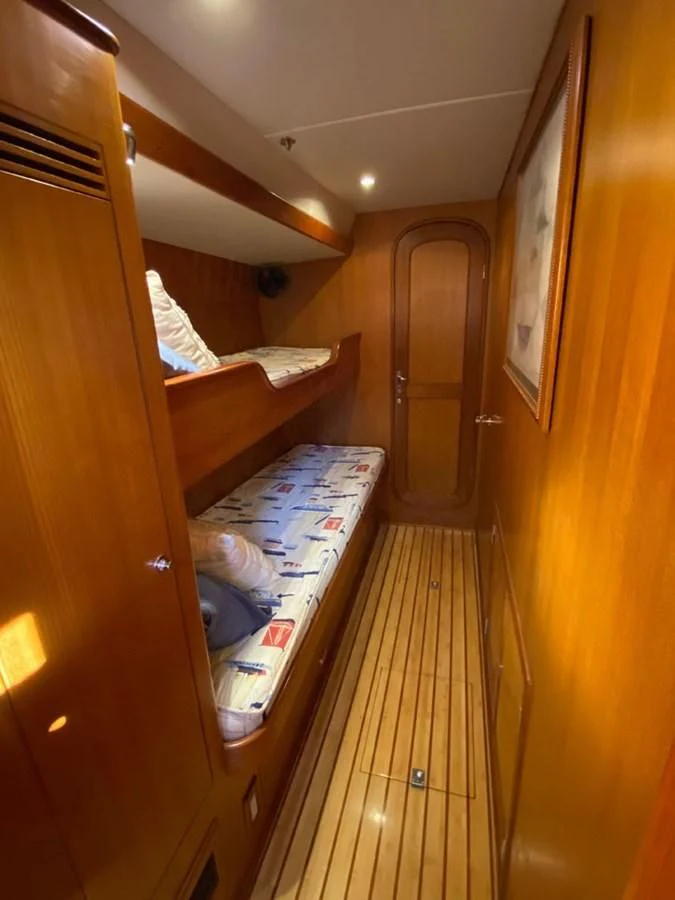 a room with a bed and a closet aboard EL CACIQUE Yacht for Sale