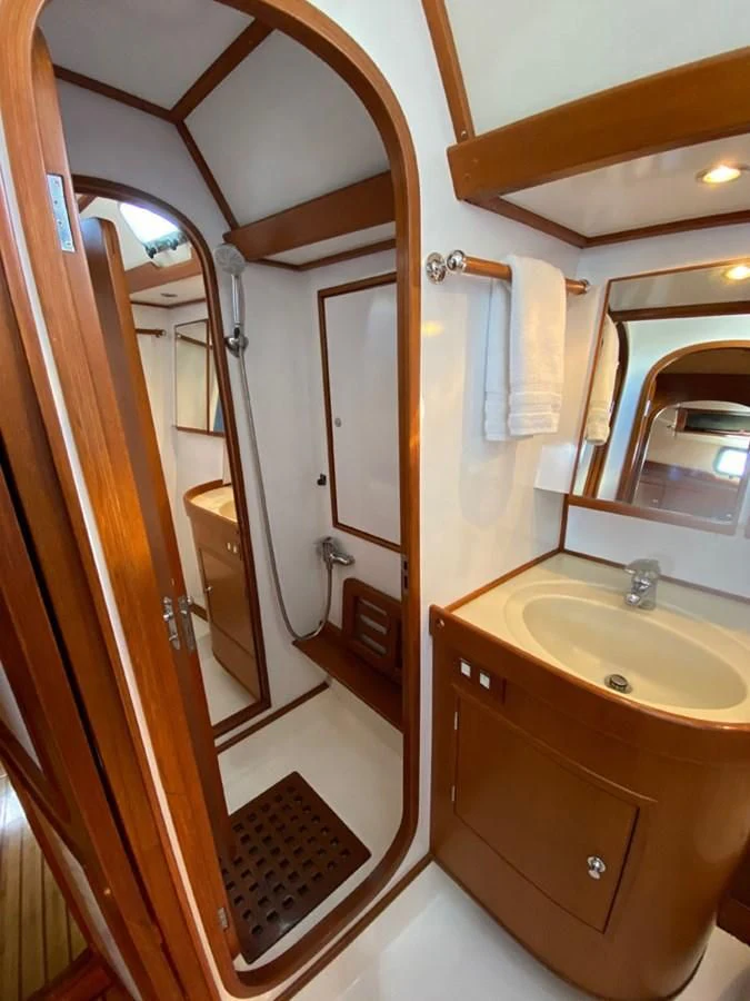 a bathroom with a sink and a mirror aboard EL CACIQUE Yacht for Sale