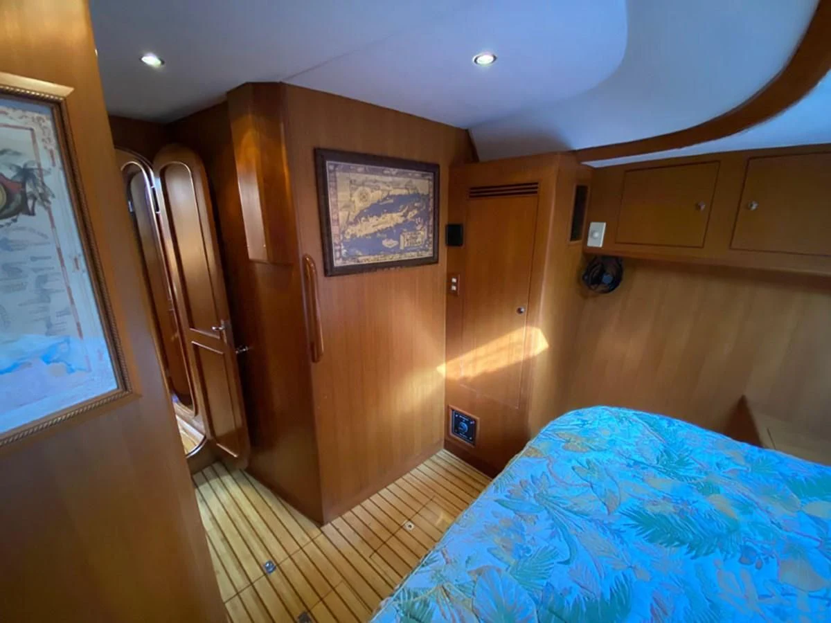 a bedroom with a bed and a door aboard EL CACIQUE Yacht for Sale